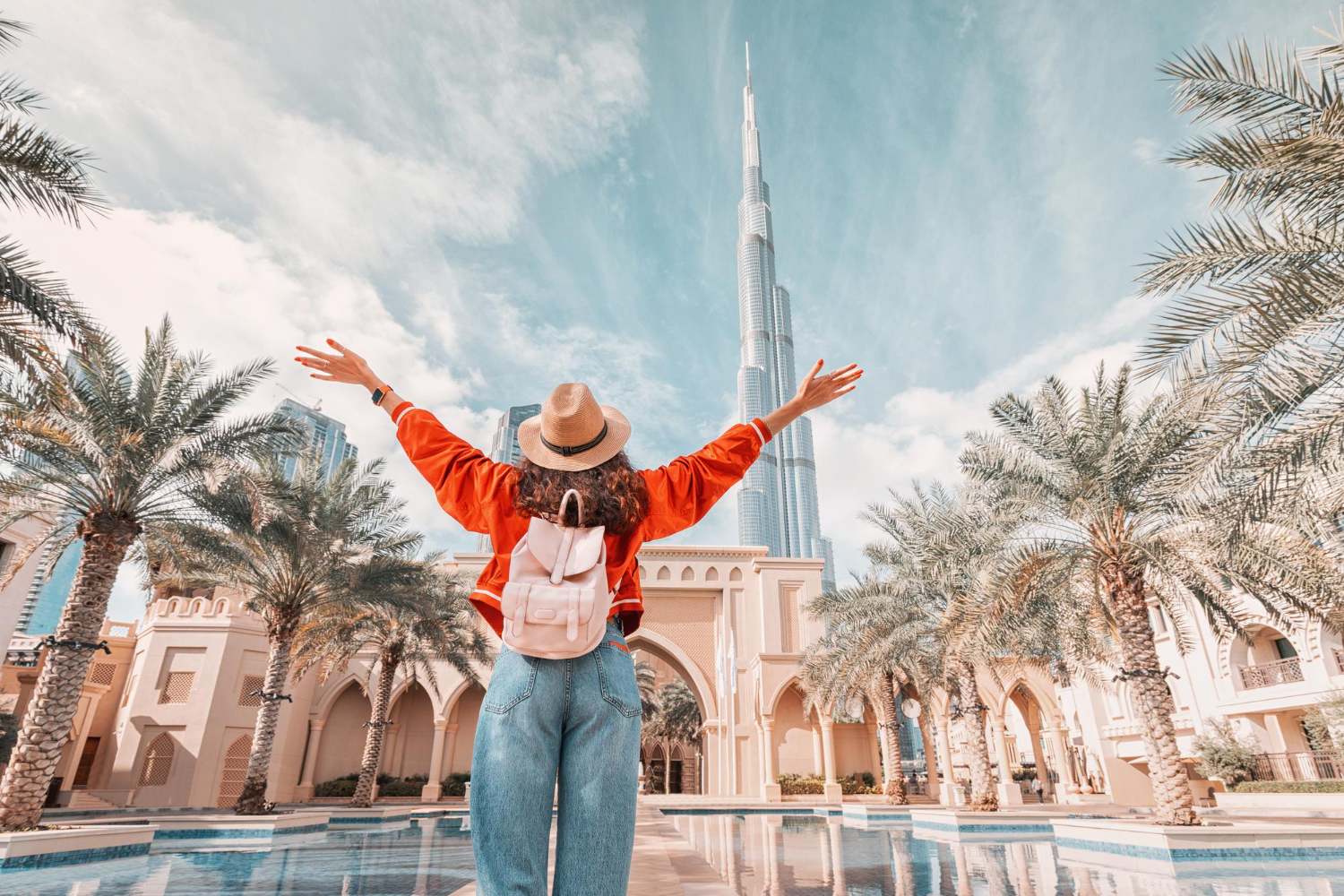 Person visiting Dubai and looking at the Burj Khalifa on a sunny day