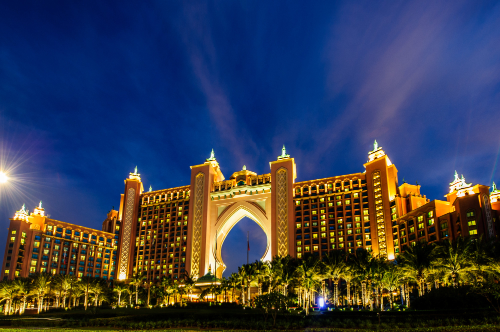 Atlantis The Palm hotel in Dubai illuminated at night during a special event, with lights, decorations, and a festive atmosphere.